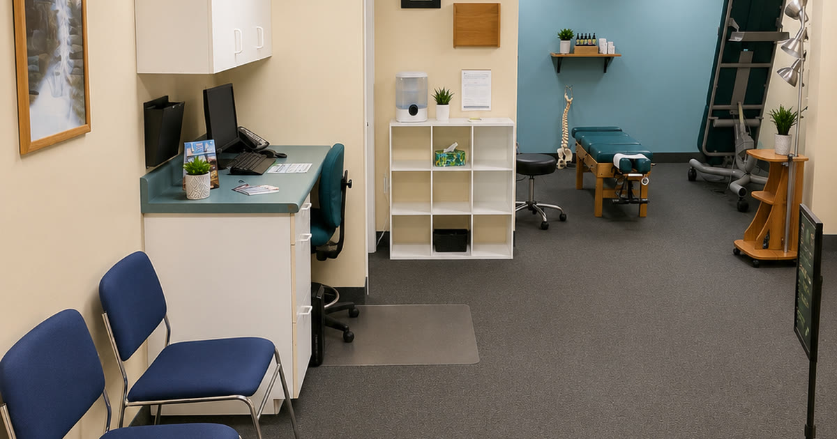 The front desk and intake area at Total Wellness Chiropractic in Bowie, MD, with the treatment room visible beyond