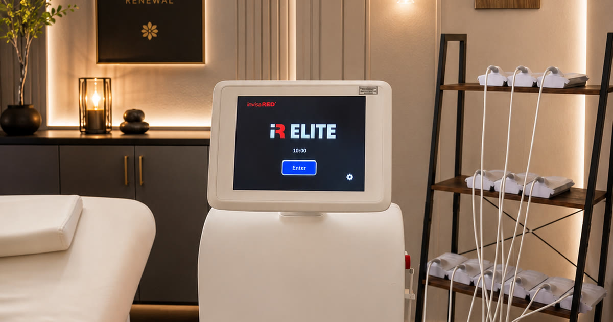 The InvisaRED iR Elite body contouring unit and its rack of treatment pads in the treatment room at Total Wellness Chiropractic in Bowie, MD