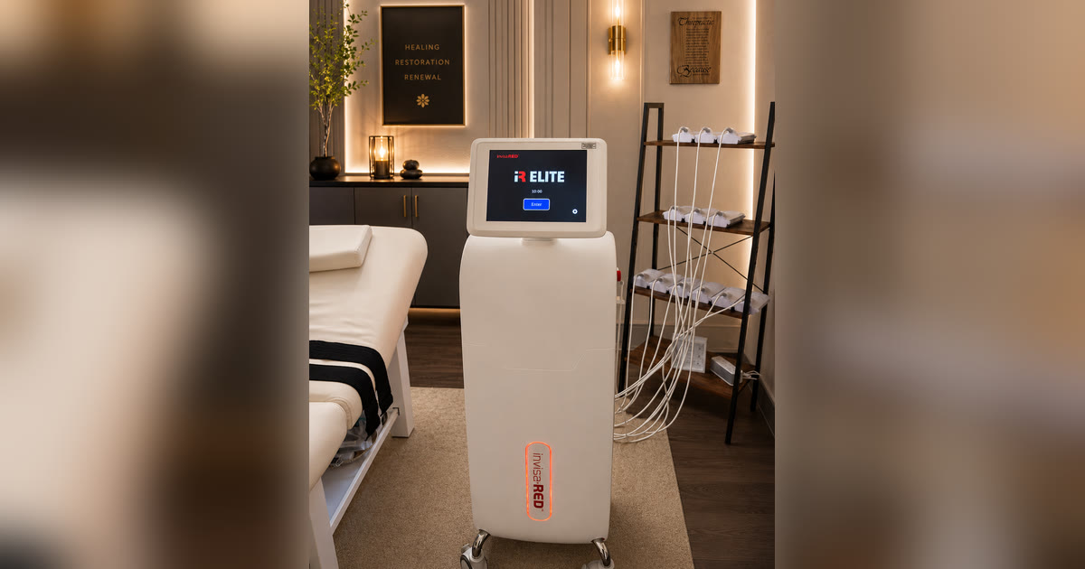 The InvisaRED iR Elite body contouring unit and its pad rack in the treatment room at Total Wellness Chiropractic in Bowie, MD